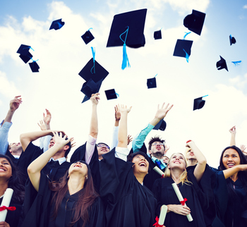 Students throwing their graduation caps in the air