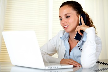 Woman reading home buying articles on her laptop
